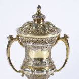 A small silver-gilt lidded 2-handled trophy, on turned wood stand, by Mappin & Webb, hallmarks