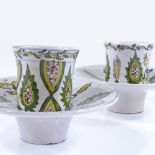A pair of Turkish painted and glazed ceramic tea cups and saucers