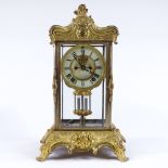 An ornate 19th century gilt-metal cased 4-glass mantel clock in Rococo style, with 8-day striking