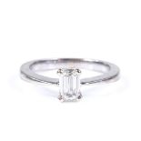 A 0.52ct emerald-cut solitaire diamond ring, unmarked settings test as platinum, setting height 6.