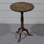 A 19th century circular mahogany dish-top wine table on tripod base, 19" across