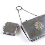 A rectangular silver evening purse, with central armorial, by Henry Williamson Ltd, hallmarks