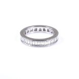 A platinum and baguette-cut diamond full eternity ring, band width 3.9mm, size K, 5.2g
