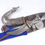 An Arab white metal mounted jambiya knife with belt and fittings