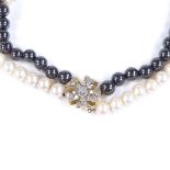 A 2-colour double strand pearl choker necklace, with unmarked gold diamond set spacer and silver-