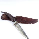 A German Second War Period horn-handled knife, with embossed leather scabbard