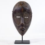 A Dan tribal carved wood mask.