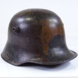 A German 1st war period military M17 camouflage tin helmet