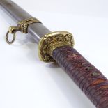 A Japanese 20th century sword, canvas-bound handle with cast-brass tsuba, original brass-mounted