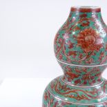 A Chinese porcelain double-gourd vase, with green and red painted floral decoration, 6 character