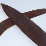 An Aboriginal hardwood boomerang, with engraved zigzag designs, and a similar engraved woomera,