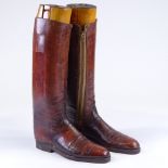A pair of Vintage brown leather riding boots, with wooden trees