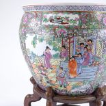 A Chinese famille rose porcelain fish bowl, with enamel decoration on wooden stand, rim diameter