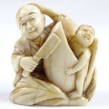 A Japanese Meiji period carved ivory netsuke in the form of 2 figures, height 3cm