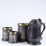 A set of 3 Antique brass-rimmed pewter measures, and a Victorian lidded pewter tankard (4)
