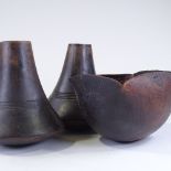 A pair of African turned hardwood vases, height 24cm, and a similar carved wood bowl, length 26cm (