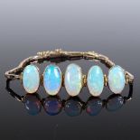 An Edwardian unmarked gold 5-stone opal panel bracelet, largest panel 14.8mm, internal diameter