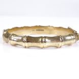 A 9ct gold simulated bamboo hinged bangle, internal diameter 54mm, internal height 49mm, 15.9g