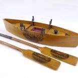 A Mauchline Ware desk stand in the form of a rowing boat and oars (the oars are dip pens), with