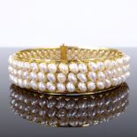 A Middle Eastern unmarked gold freshwater pearl bangle, band width 17mm, internal diameter 62.5mm,