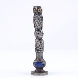 A Victorian novelty unmarked white metal owl desk seal, with coloured glass eyes and cabochon