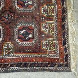 A small brown ground handmade Bokara rug, 5' x 2'10"