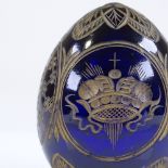 A Russian blue glass egg with engraved gilded design, Faberge label under base, height 7cm