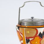 A Clarice Cliff Bizarre Fantasque design rocket-shaped biscuit barrel, with nickel plate mounts,