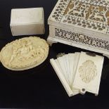 A 19th century bone fretwork decorated jewel box, length 14cm, a Chinese relief carved ivory card