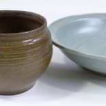 A Chinese celadon crackle glaze bowl, diameter 30cm, and a Chinese treacle glaze pottery jardiniere,