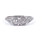 An 18ct white gold 2-stone diamond dress ring, with diamond set shoulders and pierced bridge,