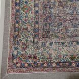 An Antique handmade ivory ground Kirman rug, 11'7" x 8'10"