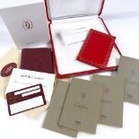 A boxed Cartier address book, a Cartier jewellery case and papers