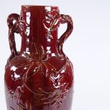 A Clement Massier Pottery Golf Juan France red glaze 2-handled vase, with relief designs