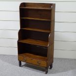 A 19th century mahogany waterfall open bookcase, with drawer fitted base and turned legs, width