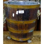 A Victorian coopered oak bucket, with metal liner, brass lion mask ring handles, on lion paw feet,