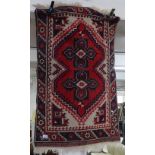 A red ground Afghan design rug, 105cm x 70cm