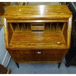 A mid-century teak bureau, with tambour front, above a slide with further drawers under, and