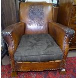 A 1920s studded leather upholstered Club armchair