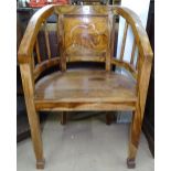 An African hardwood bow-arm desk chair, with elephant design panelled back