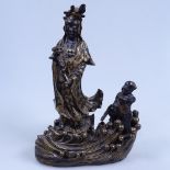 A Chinese gilded and black glaze ceramic figure of Buddha, on wave design base, height 24cm