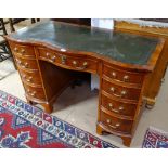 A reproduction serpentine-front mahogany lady's writing desk, with green leather skiver and 9 fitted