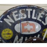 An Antique oval Nestle's Milk enamel advertising sign, length 56"