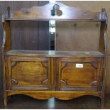 An Edwardian hanging cabinet with carved panelled doors, W58cm