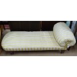 A Victorian day bed, in cream and gold striped upholstery, raised on turned mahogany legs, L170cm