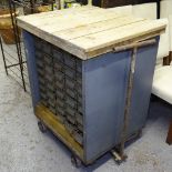 An industrial grey metal 45-drawer cabinet, with pine plank top, on wheeled base, W77cm, H96cm