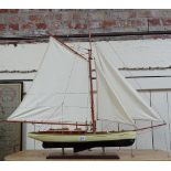 A painted model yacht on stand, length 36" overall