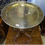 A Chinese engraved brass-top table, on folding base, W60cm