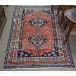 A red ground Turkish rug with symmetrical pattern, 165cm x 104cm