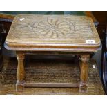 A small 1920s carved oak stool, on baluster legs, W43cm